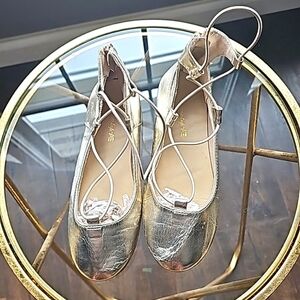 American Eagle metallic gold slippers with zip backs and elastic string. Size 2